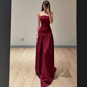 Detail of burgundy strapless maxi dress with tie-back design and high-waisted cut