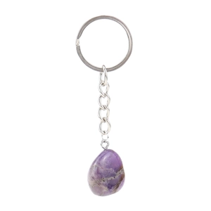 Detail view of a natural purple amethyst stone pendant on a silver metal keychain