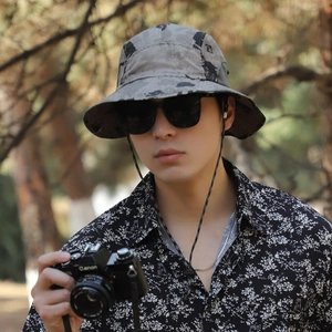 Outdoor camouflage bucket hat with adjustable chin strap and wide brim for hiking