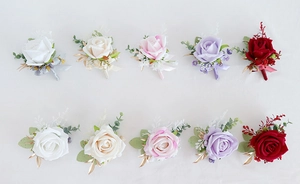 Various colors of artificial rose boutonnieres and wrist corsages for wedding decor
