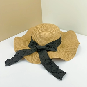 French handmade straw hat with wide brim and black lace bow for beach sun protection