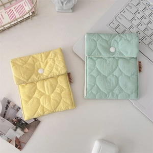 Close-up of heart-quilted candy color mini storage pouches with white snap buttons