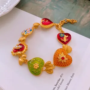 Vintage enamel heart bracelet with colorful charms and baroque pearls in a gold finish