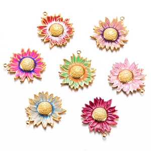Macro detail of colorful enamel sunflower pendants with gold-plated stainless steel frames