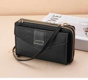 Detail view of black dual-zipper crossbody phone bag with pebble texture flap