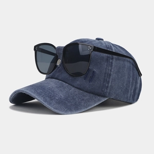 Detail of vintage navy baseball cap featuring integrated black aviator sunglasses