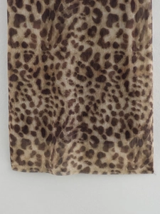 Macro detail of high-quality leopard print sheer mesh fabric with soft drape