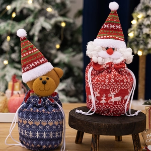 Festive knitted Christmas drawstring gift bags featuring Santa and bear characters