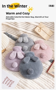 Detail of plush rabbit ear hot water bottles in purple, pink and grey soft fur