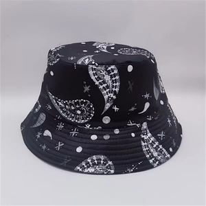 Close-up of black bucket hat featuring white paisley leaf prints and street style star motifs