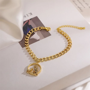 Detail of gold Cuban chain bracelet featuring a leopard pendant with zircon accents