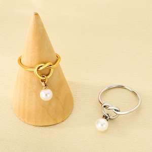 Minimalist stainless steel knot rings with pearl charms in gold and silver finishes