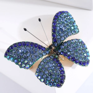 Elegant silver butterfly brooch with sparkling blue and green crystals for women's suits