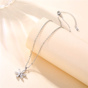 Macro detail of silver flower pendant necklace featuring sparkling cubic zirconia stones