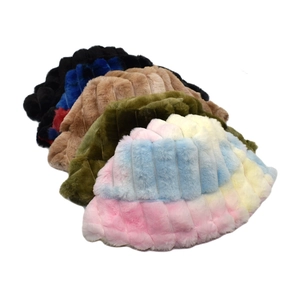 Close-up of plush faux fur bucket hats in rainbow and solid colors with quilted stripes
