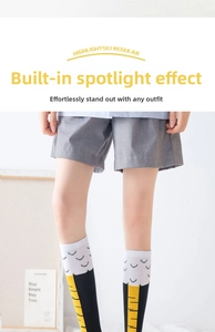 Detail of creative chicken feet knee high socks with yellow claw pattern on white