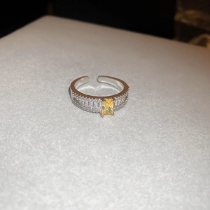 Macro view of adjustable ring featuring a radiant yellow rectangular zircon center stone