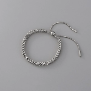 Macro detail of silver wheat chain bracelet with adjustable pull-string slider closure