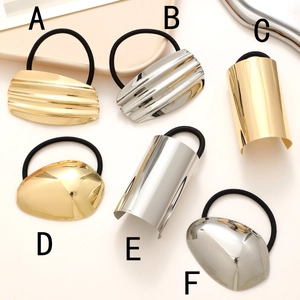 Polished geometric metal hair ties in gold and silver finishes with elastic bands
