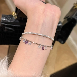 Elegant silver layered bracelet with purple zircon teardrop charms and sparkling pavé cuff