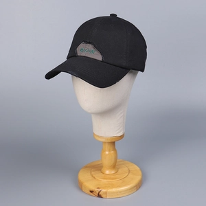 Close-up of black cotton baseball cap with distressed patch and green RUN embroidery