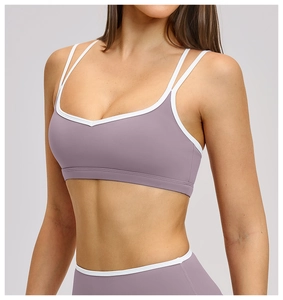 Close-up of lilac sports bra with white piping and double thin straps for yoga