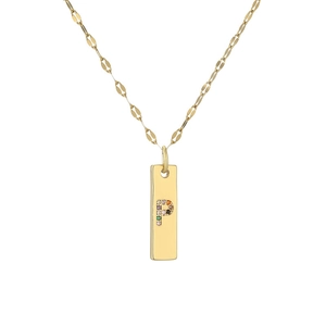 Macro shot of gold-plated rectangular pendant with colorful gemstone letter P engraving