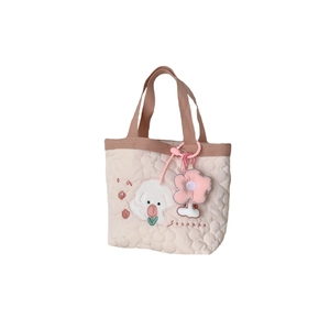 Pink quilted tote bag with cute dog embroidery and a floral pendant on white background