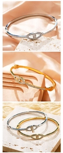 Macro detail of gold and silver evil eye bracelets with pave-set shimmering crystals