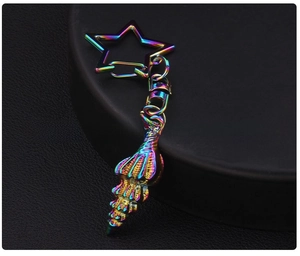 Close-up of a colorful iridescent metal conch shell keychain with a star-shaped clasp