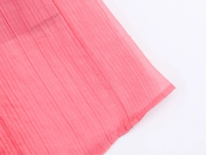 Macro shot of pink pleated chiffon fabric with vertical stripes and fine stitching details