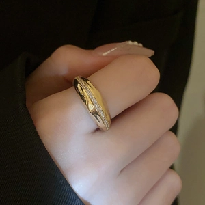 Detail of gold plated irregular lava ring with pavé cubic zirconia on fingers