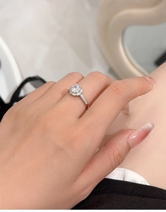 Detailed close-up of a S925 sterling silver ring with a one-carat moissanite on a model hand