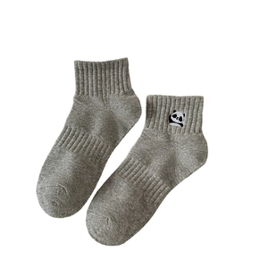 Gray cotton ankle socks with cute panda embroidery on the ribbed cuff in a flat lay view