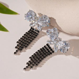 Detailed macro view of butterfly zirconia earrings with long black rhinestone tassels