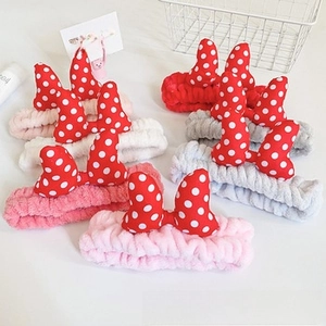 Macro detail of soft coral fleece bow headbands in various colors for skincare