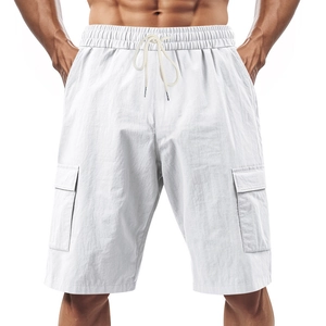 Detail of white cotton linen cargo shorts with drawstring waist and large side pockets