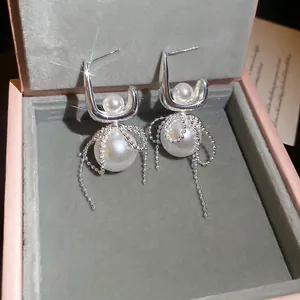 Elegant silver bow earrings with pearls and long tassel fringe in a luxury gift box