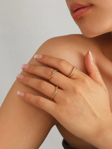 Detail of three stacked 18k gold plated wave rings with sparkling zircon micro-pave