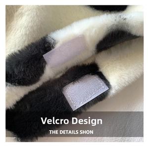 Macro detail of cow print plush fabric featuring a secure velcro closure strap