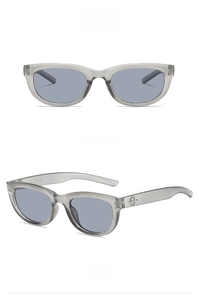 Detail view of retro cat-eye sunglasses in grey frame with metallic logo on temples