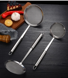 Three-piece stainless steel fine mesh strainer set on a dark wood kitchen table