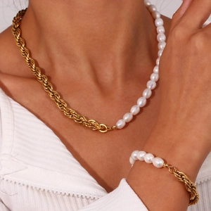 Gold twist chain necklace and bracelet set with freshwater pearls on a model
