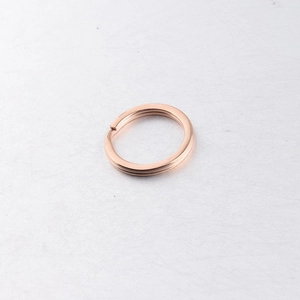 Detail of a rose gold mirror-polished stainless steel split key ring for DIY hardware