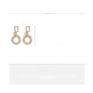 Detail view of pearl and crystal drop earrings with precise dimensions 4.5 by 2.5 cm