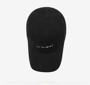 Top down view of black baseball cap with gray NY letters and white arched embroidery