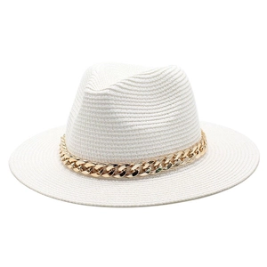 Detail shot of white straw Panama hat featuring a stylish gold chunky chain decoration
