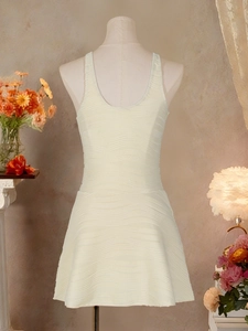 Elegant cream sleeveless A-line dress with wavy texture on a mannequin in a cozy setting