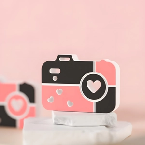 Pink heart camera ornament on marble stone base with minimalist aesthetic design