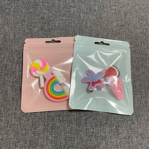 Detail view of colorful lollipop and starfish hair clips in premium sealable gift bags